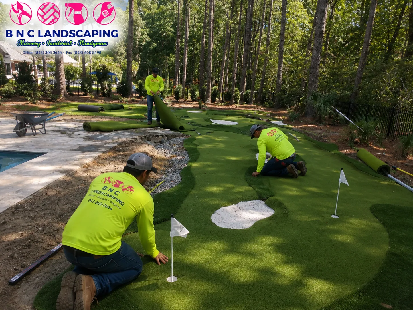 BNC Landscaping crew installing artificial turf around a backyard putting green